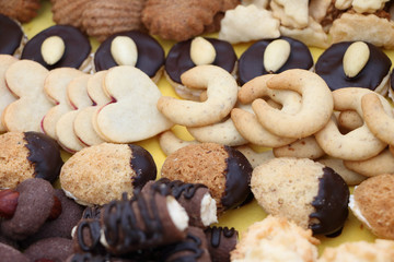 Detail photo of various homemade Christmas cookies, special Czech sweets on yellow background. Pastry, cookies, biscuit, cracker with spice (vanilla, cinnamon) and nuts (walnuts) like tea biscuits
