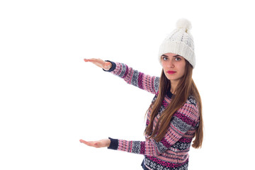 Woman in sweater and white hat holding something 