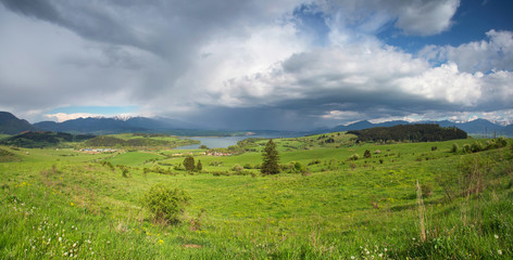 Stormy clouds over green fields