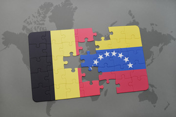 puzzle with the national flag of belgium and venezuela on a world map background.