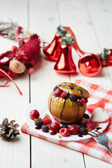 Baked apple with berries and chocolate sauce. Wooden background. Healthy lifestyle.Diet and weight loss concept. Low calories dinner. Vitamin B. Healthy food.