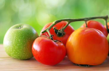 Ripe natural tomatoes, apple and diospyros