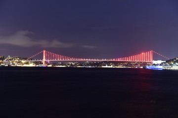 Istanbul bosphorus bridge with red lights at night