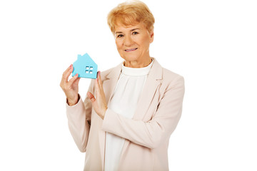 Smile elderly business woman holding blue paper house