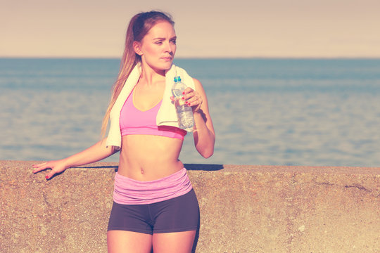 Woman drinking water after sport gym outdoor