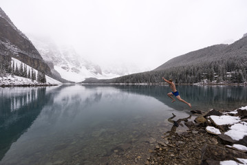 Man jumps into freezing cold blue lake in the snow