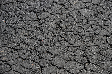 Naklejka premium cracked asphalt road surface background