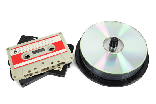 Audio cassettes and CDs on white background