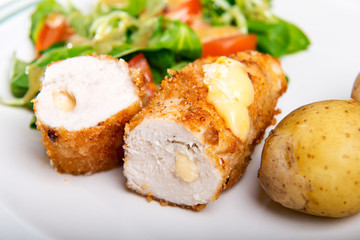 Kiev cutlet with jacket potatoes and salad
