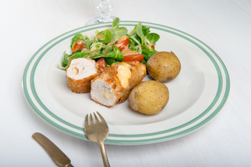 Kiev cutlet with jacket potatoes and salad