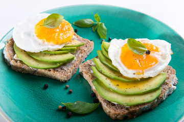 Sandwich with avocado slices and basil