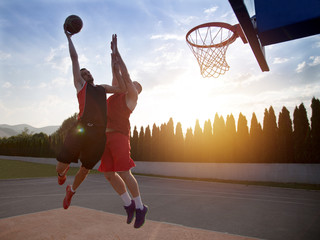 Two basketball players on the court outdoor