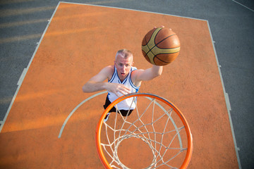Basketball street player making a slam dunk © FS-Stock