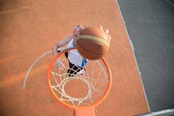 Basketball street player making a slam dunk