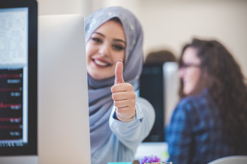 portrait of woman wearing hijab and giving thumbs up