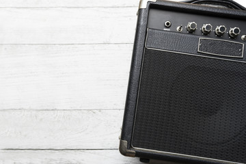 Guitar amplifier on white wood table