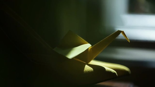 Origami paper bird spinning in wind, handmade, Japanese art of paper.