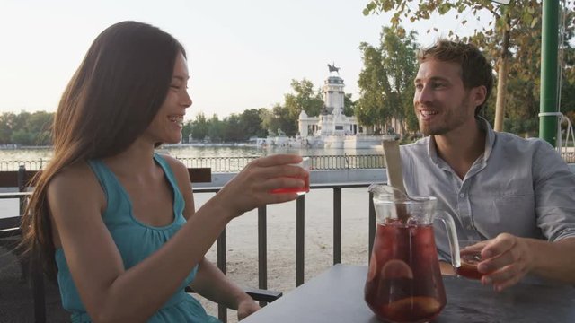 Couple drinking sangria in cafe outdoors in Madrid, Spain in El Retiro city park. Romantic couple, woman and man lifestyle in Buen Retiro Park, Parque el Retiro in Madrid, Spain, Europe.