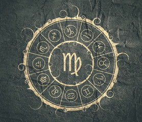 Astrological symbols in the circle. Concrete wall textured. Maiden sign