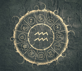 Astrological symbols in the circle. Concrete wall textured. Water bearer sign
