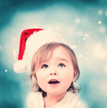 Happy toddler girl with Santa hat