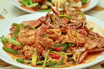 Close up of stir-fried crab and shrimp in curry power is top-ten of popular Thai food as seafood to fried with  fresh milk ,grill curry ,egg ,oyster oil and yellow curry power. Selective focus.