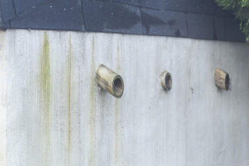 Ventilation pipes on the wall.