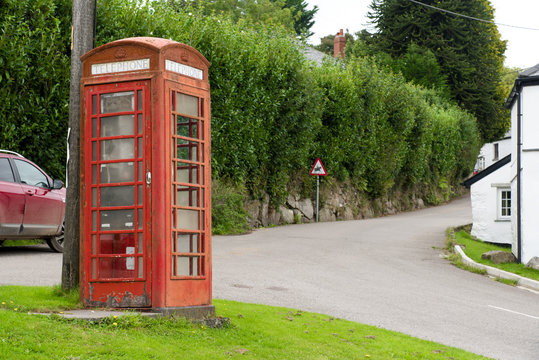 Weather-beaten red phone box in Henwood on the edge of the Bodmin Moor in Cornwall.