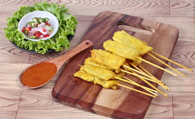 Charcoal boiled pork satay on butcher served , home made in big size, served with Thai cucumber chili sauce as 