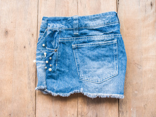 Short jean on wood background

