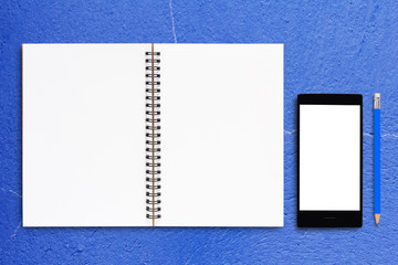 Notebook and Mobile Phone on Blue Background