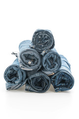 stacks of jeans clothing on white