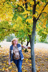 Mature woman in the autumn forest