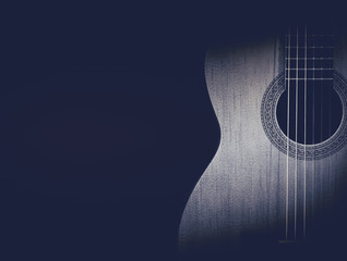 Part of a blue acoustic guitar on black background.