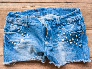 Short jean on wood background

