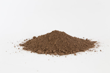 Pile of  brown  soil on white background