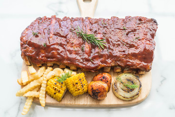 Grilled rib pork with barbecue sauce and vegetable and frech fri