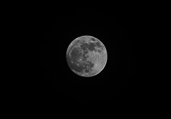 full moon over dark black sky at night