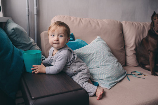cute happy 11 month baby boy playing at home, lifestyle capture in cozy modern interior