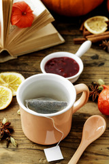 Jasmine tea in ceramic jug standing on wooden table.