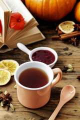 Jasmine tea in ceramic jug standing on wooden table.