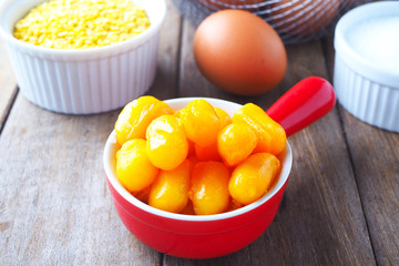 Close up of traditional Thai sweet jack fruit seeds dessert in a red bowl.