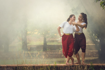 Two Beautiful young girl Thai Dancing art, pantomime performance