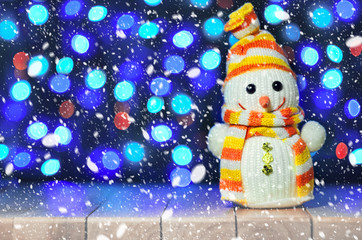Happy snowman with lights in the background