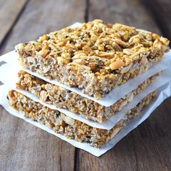 Top view of stack of square rice crispy treats on a waxed paper.