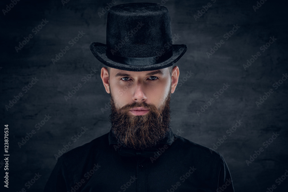 Wall mural Bearded male with tattoo on his neck and top hat cylinder on hea