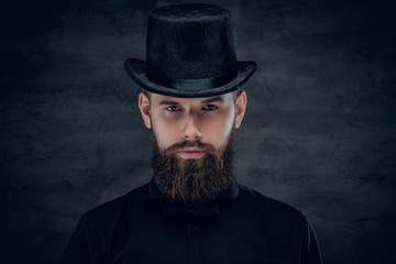 Bearded male with tattoo on his neck and top hat cylinder on hea