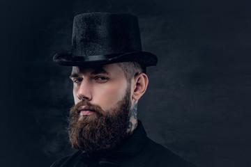 Close up portrait of bearded male with tattooed neck.
