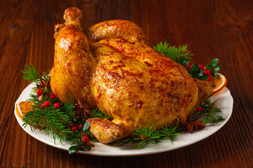 Roasted whole chicken with Christmas decoration.