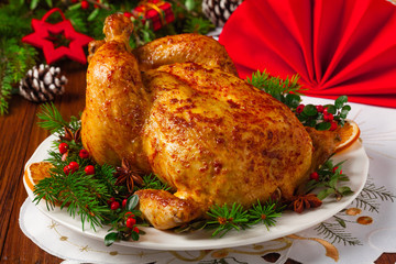 Roasted whole chicken with Christmas decoration.